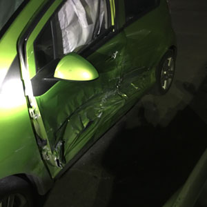 Green car wrecked from car crash