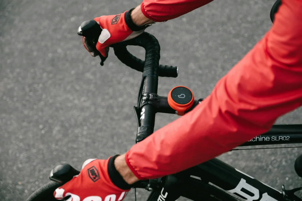 Man wearing red longsleeve riding a bike