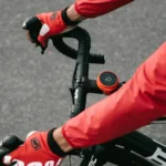 Man wearing red longsleeve riding a bike